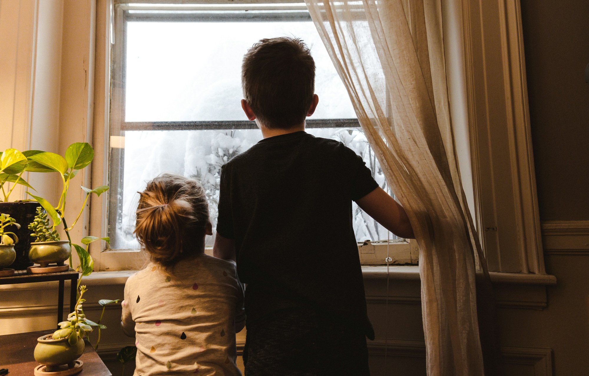 Kids at home looking out the window